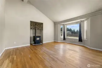 Wood burning stove, picture window and nice hardwood floors