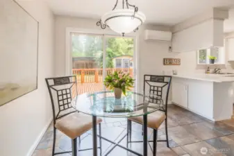 Dining Area with kitchen to the right and slider to back yard and deck.