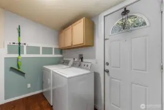Laundry room with additional cabinets for storage.