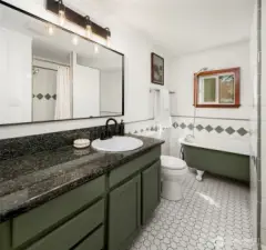 Sweet claw-foot tub and separate tiled shower in the bath.
