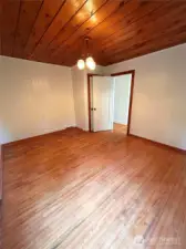 Main floor bedroom with cedar closet and knotty pine ceiling