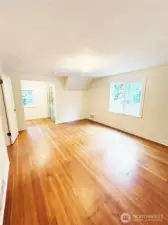 Upstairs bedroom features oak hardwood floors, custom built-in displace hutch and cedar closet.