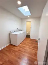 Spacious mudroom with utility sink, access to 2 car garage