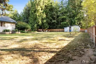Raised garden beds on the left get a ton of sunshine! Property backs up to greenspace, so this backyard is perfectly private!