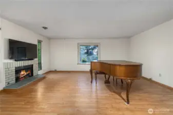 Just off the foyer, the large living room with cozy, wood-burning fireplace invites you into the space.