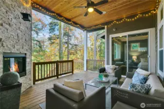 Covered porch with access from living space & primary suite. Your personal arboretum & trails below. (Bedroom blinds for privacy)
