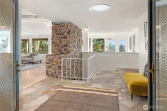 The double doors open up to a massive formal entry with granite flagstones and an enormous greeting area.