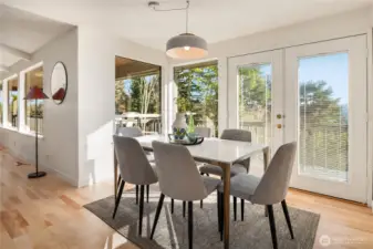 Between the formal living room and kitchen is this formal dining room with french doors that lead out to the full length deck and views of the lake.