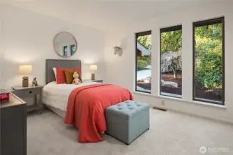 The second main floor bedroom features a new carpet, a large closet plus built-in desk area.