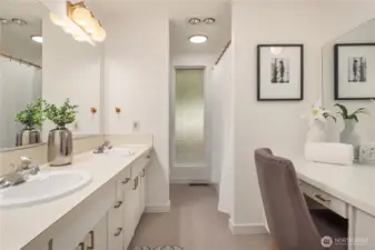 The main bathroom features lots of storage, dual vanities, new lighting, new flooring and a wonderful makeup desk with full width mirror.