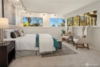 The fourth bedroom located downstairs features windows on 2 walls and amazing space.