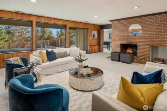 The brick fireplace has a gas log lighter to get that wood fire going quickly. Just beyond the fireplace is one of two doorways to the back bonus area.