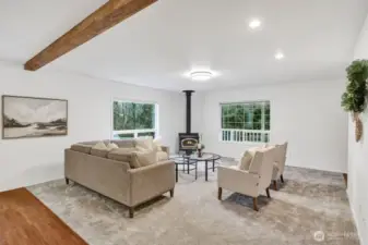 Living room with wood burning fireplace.