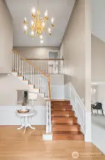 Dramatic two story entry with chandelier, note the wainscoting on the entry and the upstairs walkway.