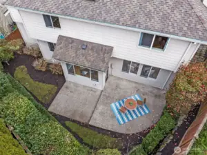 Drone view of the private backyard. Lots of mature shrubs that can be cut back or removed for more yard space.