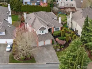 A front photo showing the dramatic landscaping, 2019 roof, and large driveway.