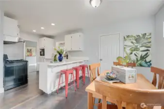 Relax on a bright red barstool and cheer the chef on.