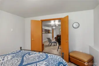 French doors of the bonus room lead to the rec room.
