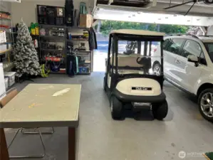 Extra large attached garage is pristine and fully furnished with room for two cars and work space area.