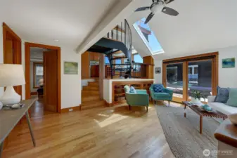 Enter the living room with vaulted ceilings and skylights. One bed/office/or both is on this level as well as the full bathroom and laundry.