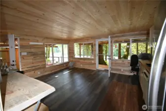 Bunkhouse features new doors, windows, updated flooring, half bath - blending modern upgrades w/rustic character. A touch of original fir floor has been preserved to stencil or paint your own design & infuse the space with personality.