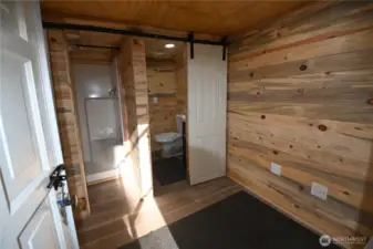 The washhouse a separate building featuring shower w/infrared heater, on-demand hot water, full laundry setup and space to add a sauna.