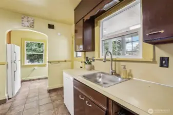 Kitchen with door to storage and side yard.