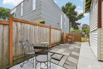 Charming side yard with cozy areas for morning coffee or afternoon picnic.