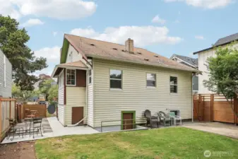 Flat rear yard has so much space to play, picnic, entertain.  Door to basement can be seen in photo.