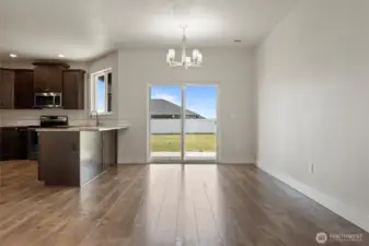 Dining area with glass slider out to covered patio