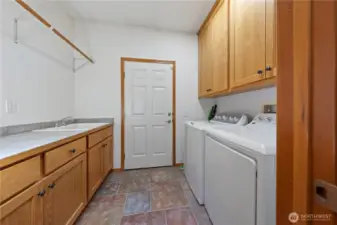 Large laundry/utility room with sink and cabinetry.