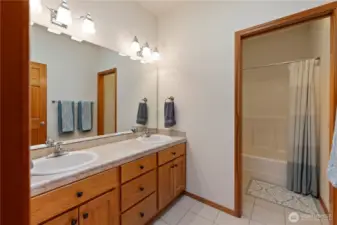 Hall or guest bathroom with double sinks and a separate shower/toilet room.