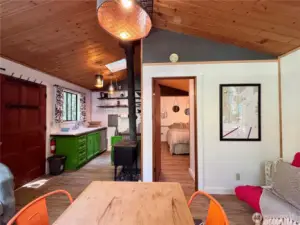 Open floor plan with wood ceilings and vinyl plank flooring.