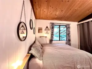 bedroom has warm wood ceilings
