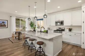 LG appliances have been well cared for and include a four burner natural gas stove with center griddle. The deep stainless steel sink is accented by elegant black fixtures.