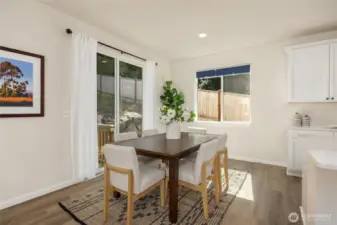 Spacious dining area overlooks the back and side yards. Light-blocking blinds are featured throughout the home, enabling lazy weekend mornings or movie nights during those long summer days.