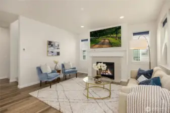 Another view of the spacious living room with laminate wood flooring.