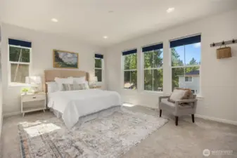 Light and bright main level primary bedroom is large enough to accommodate your furniture and a sitting area, if desired.