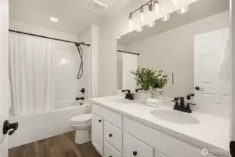 Large upper bath also features double sinks and large tub with shower.