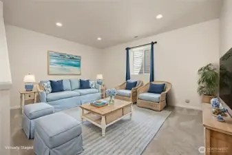 Yet another bonus or flexible use space is located on the lower level. Virtually staged as a living area, this space would be a great home office, playroom, yoga area, or even a guest space.