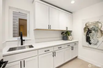Abundance of cabinets and sink in the laundry room