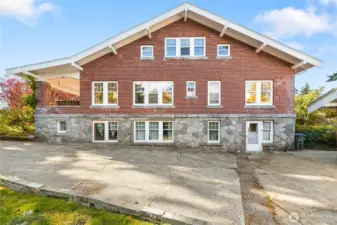 Eastside view of home highlights the beautiful brick and granite that were used in the original build. Detached garage and Cottage ADU are located to the right of this photo.