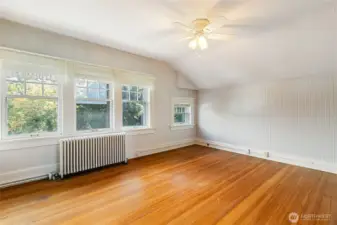 This 4th bedroom upstairs has had carpet over these wood floors for years. What a difference it makes taking out the old carpet! Love the wall of windows.