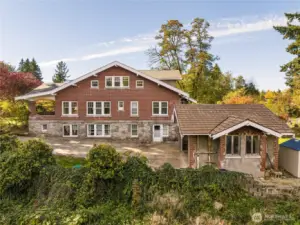 Another view of the east side of the home, and the garage at the end of the driveway. Continue past the garage to the Cottage ADU to the right.