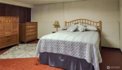 Basement ADU bedroom. To the left of the dressers is a closet.