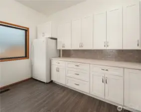 Custom spacious laundry room includes a separate freezer, W/D and additional interior storage.