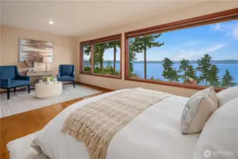 What a relaxing main bedroom to slumber and wake up in! Enjoy a morning coffee, or some stretching all while absorbing the serene water and island view.
