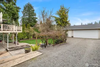 Large, Long Driveway Through Portico Leads to Backyard and 3-Car Detached Garage