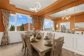 Large formal dining room with wainscoting. Hidden storage behind the mirrors.