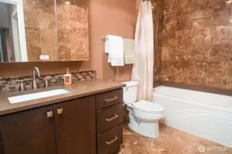 ...and a marble-tiled full bath.